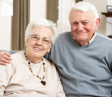Older man and woman smiling at the camera