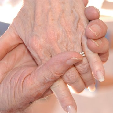 Older couple holding hands