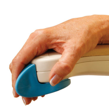 A hand operates a pale, rounded control with a blue lever; it is attached to a beige armrest against a white background.
