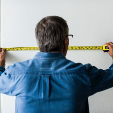 Older man measuring for stair lift installation