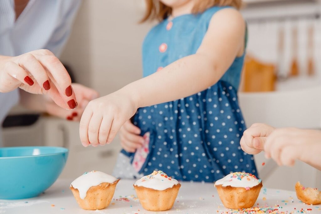 Kid decorating cupcake