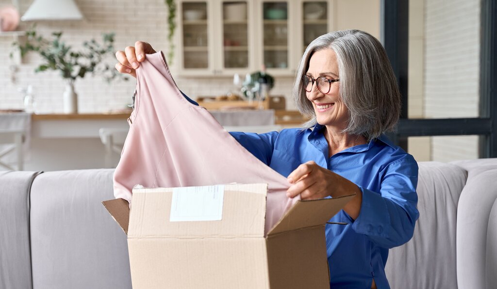 Woman looking at newly delivered t-shirt