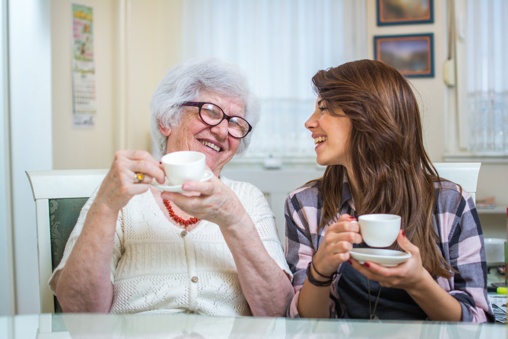 Grandparent and grandchild enjoy a cup of tea