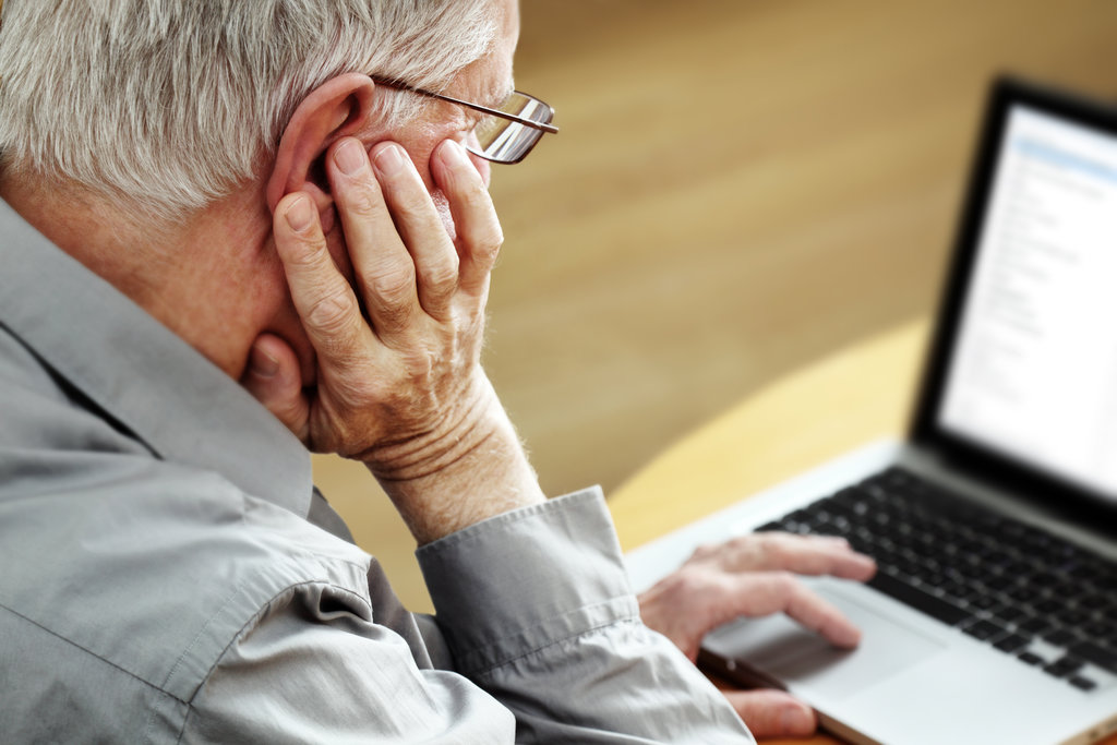 older man on a laptop