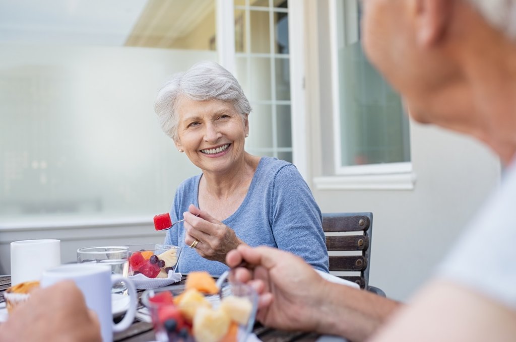 older woman eating outside