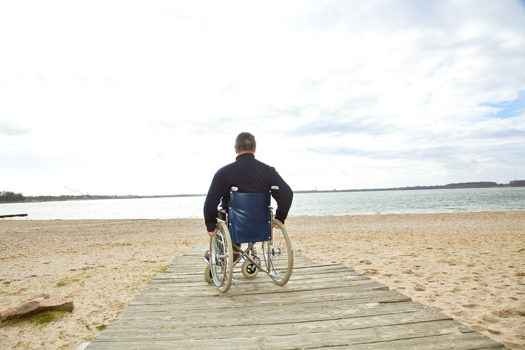 Man in wheelchair on beach