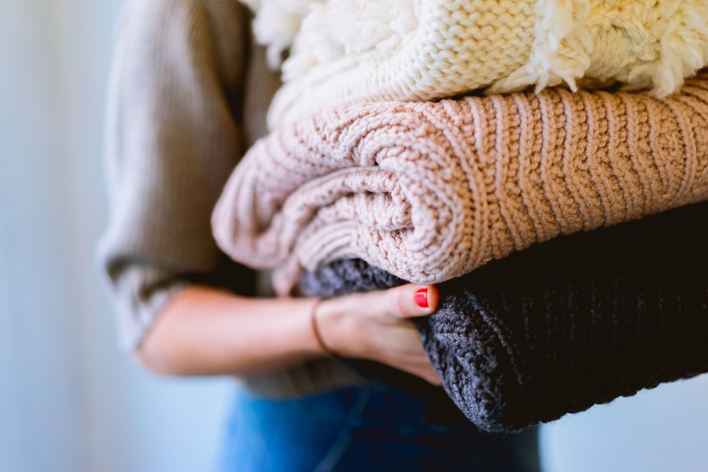 A woman using jumpers to keep warm in winter