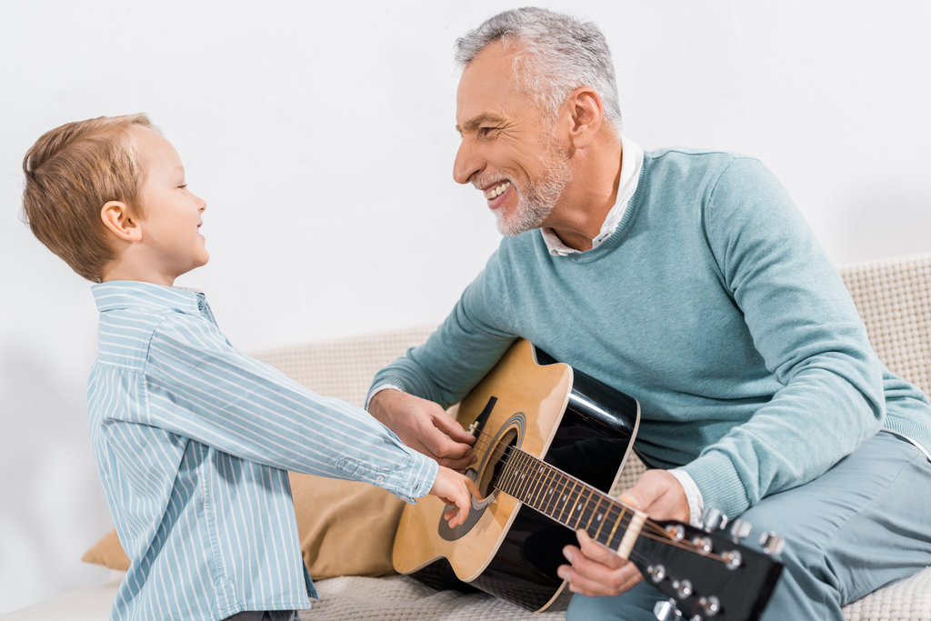 Grandad playing guitar with grandson
