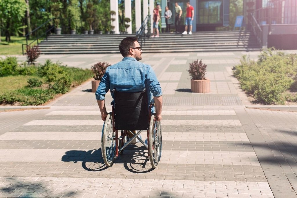 Man crossing the road in a wheelchair