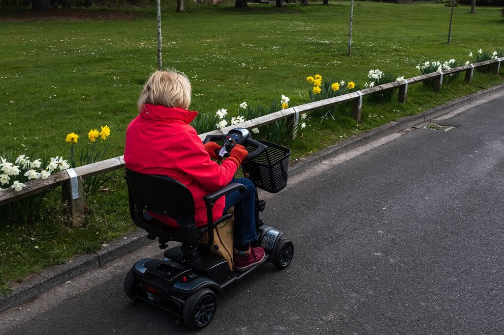 Woman driving mobility scooter