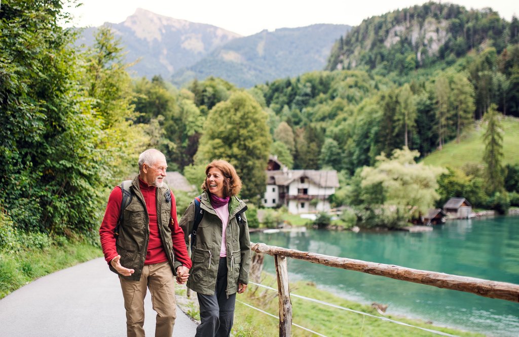 Senior couple hiking hand in hand in nature