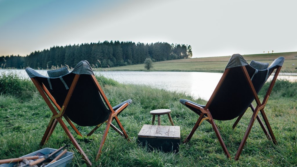 Two camp chairs in front of a lake