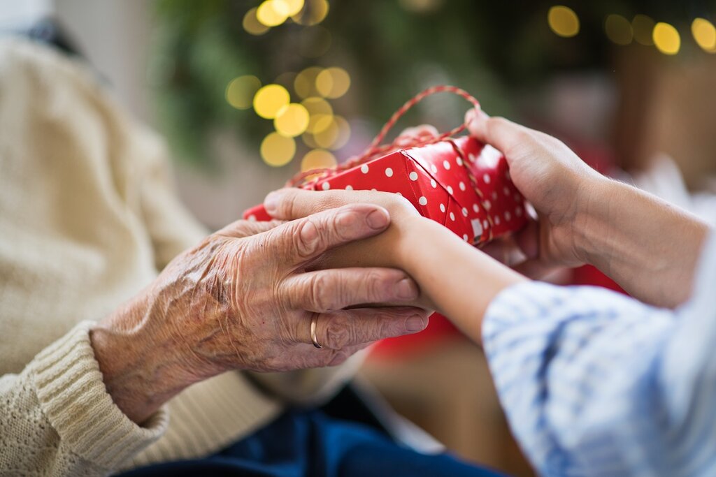 Senior lady giving a Christmas present