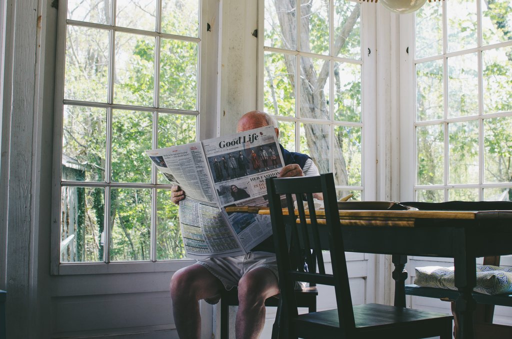 Man sat alone reading the paper