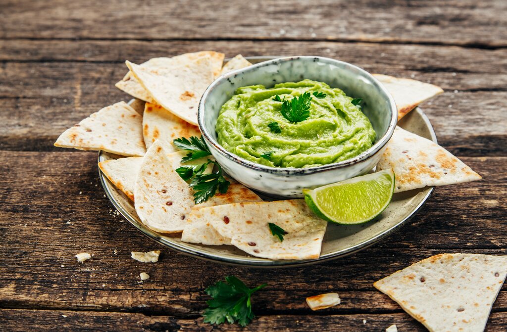 Bowl of homemade guacamole and fresh tortilla chips