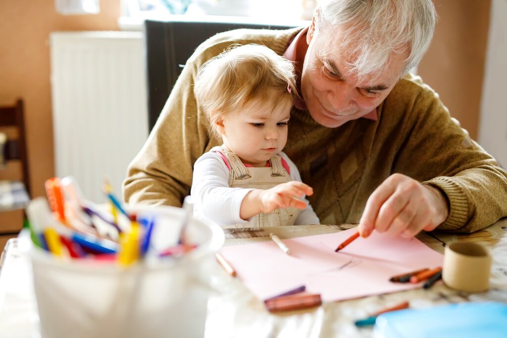 Grandfather drawing with grandchild