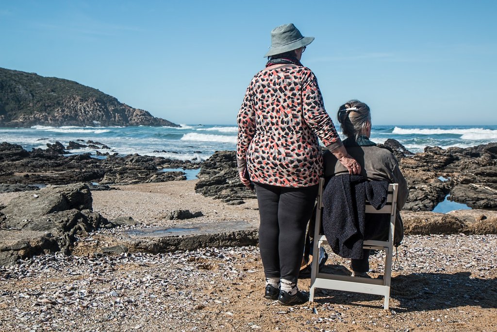 Two women on a beach looking out to sea