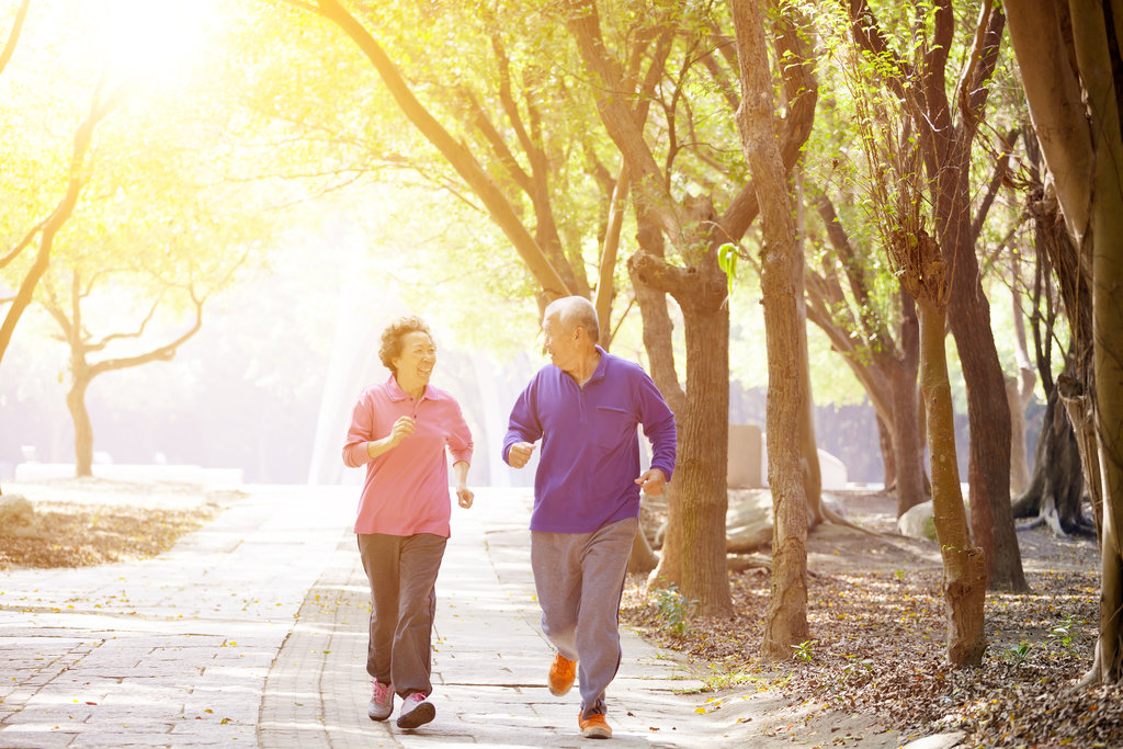 Two old people enjoying a jog