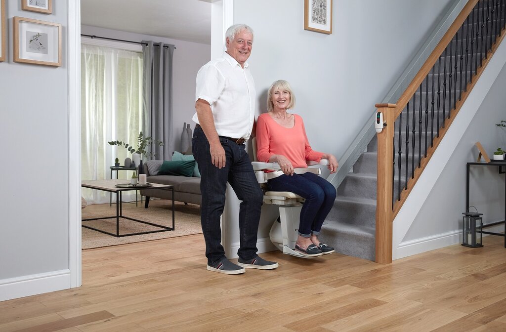 Lady on a stairlift next to her partner