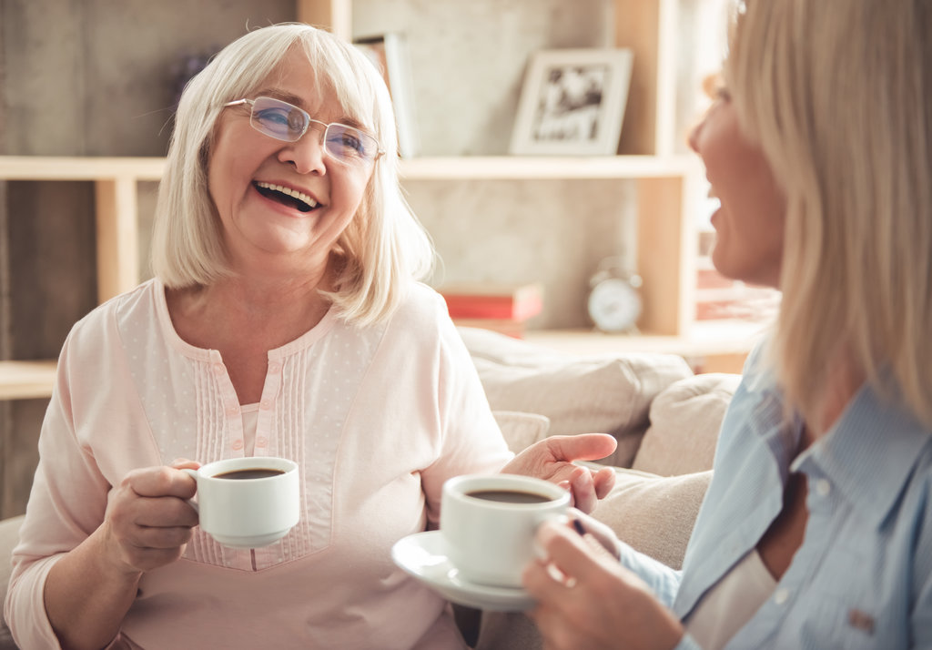 Older woman laughing with her daughter