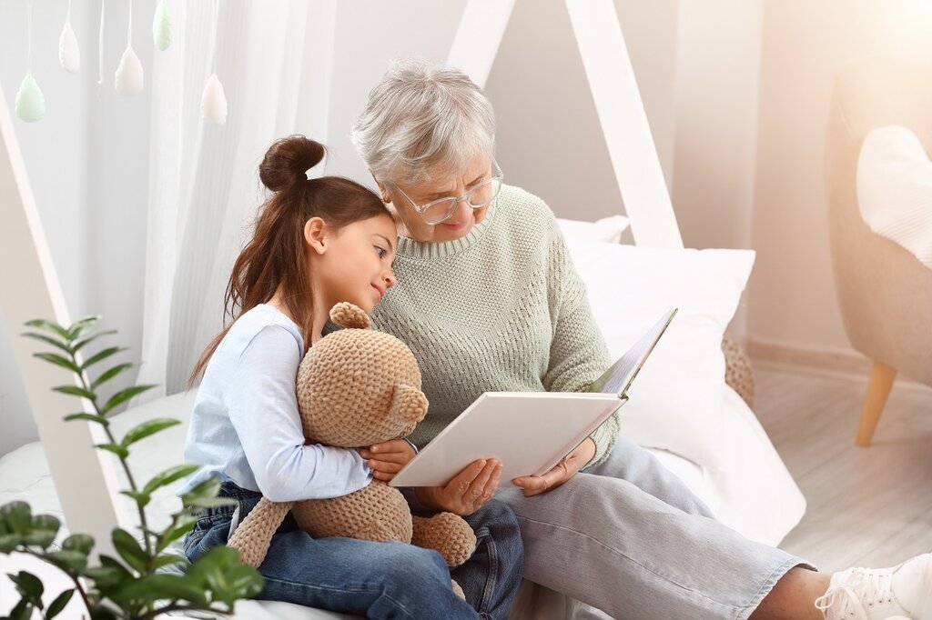 Grandmother reads to grandaughter