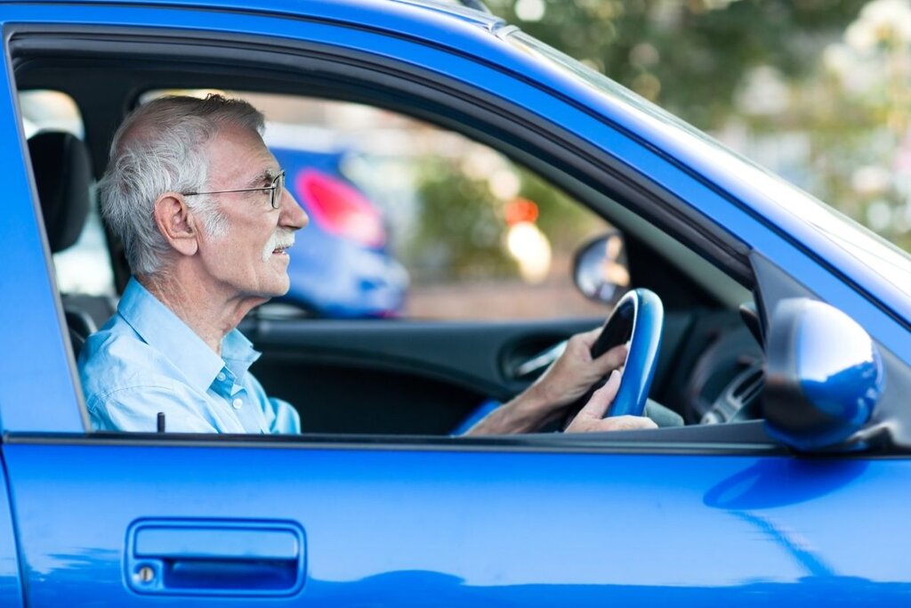 Man driving blue car
