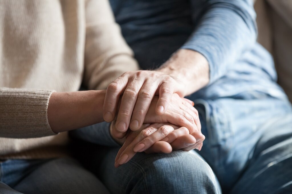 Mature couple holding hands