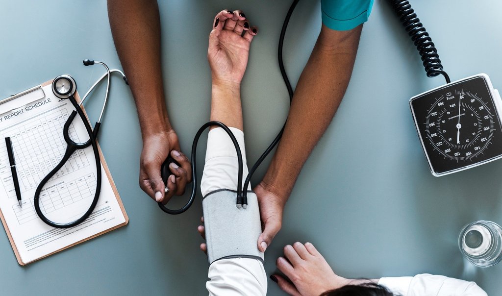 A doctor taking blood pressure