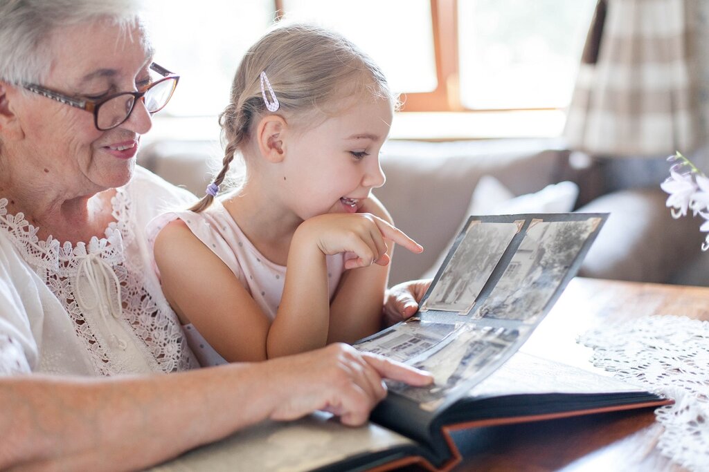 Grandmother and grandchild looking at photos