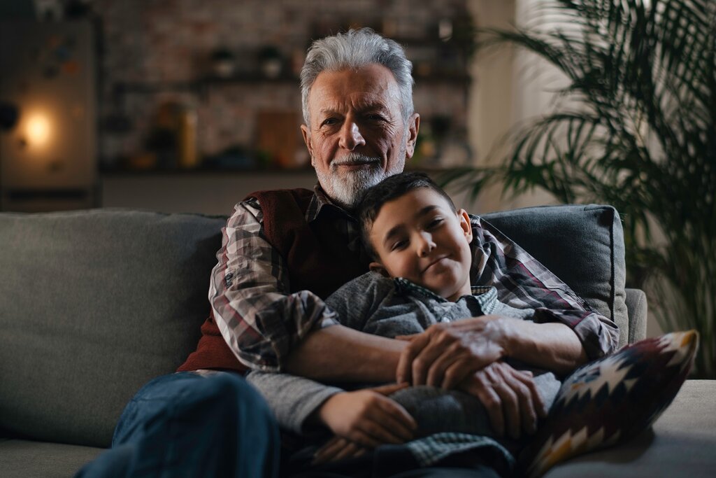 Grandad and grandson watching a film