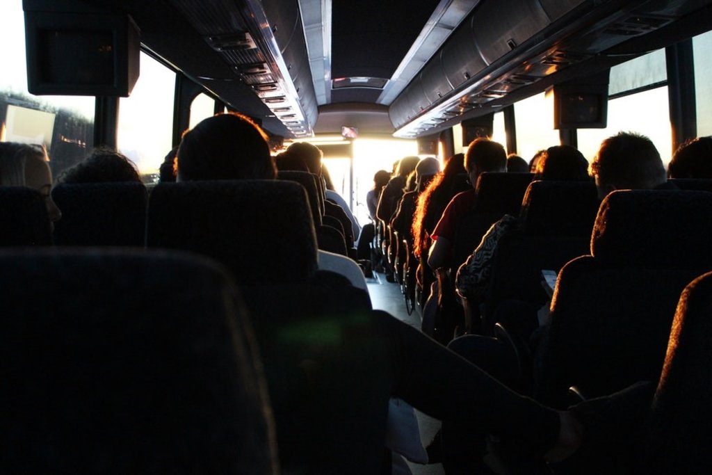 People on a coach at sunset