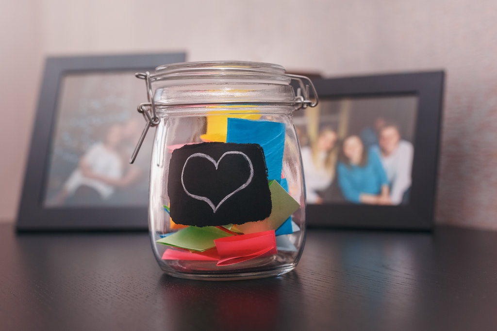 Glass jar filled with colourful paper