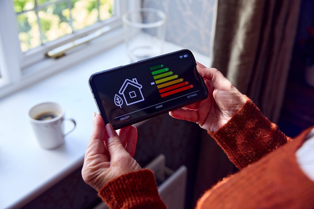 A mobile phone displaying the energy usage of a home