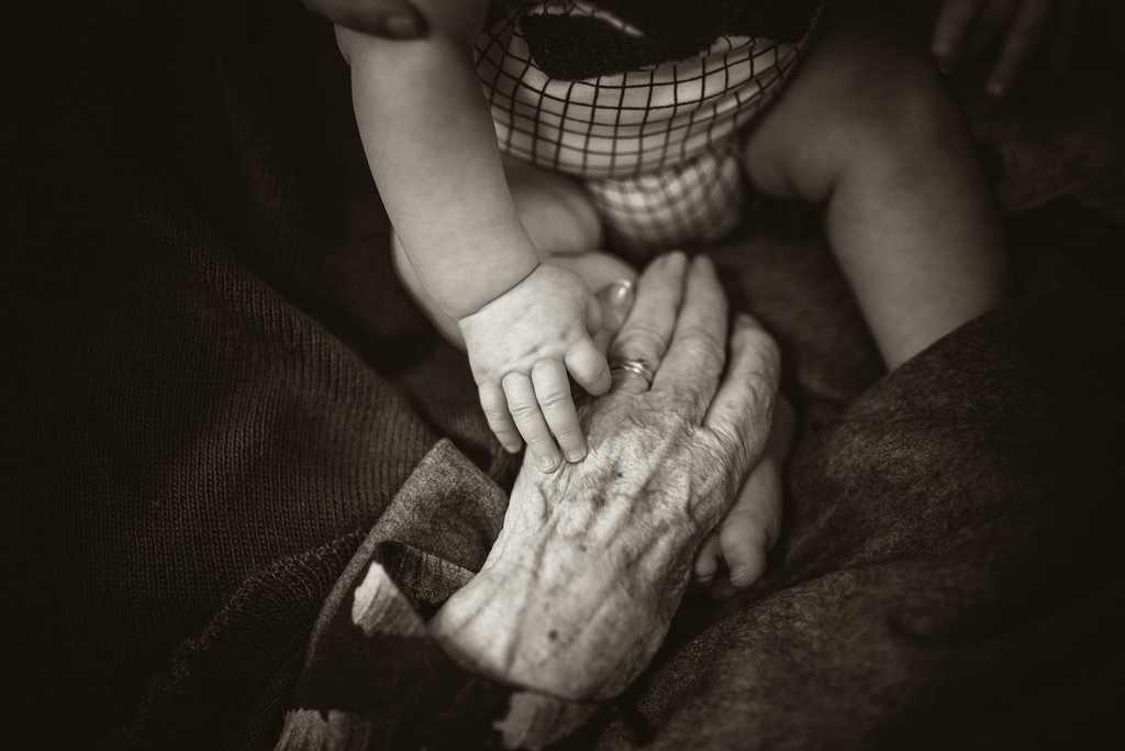 young and old hands together