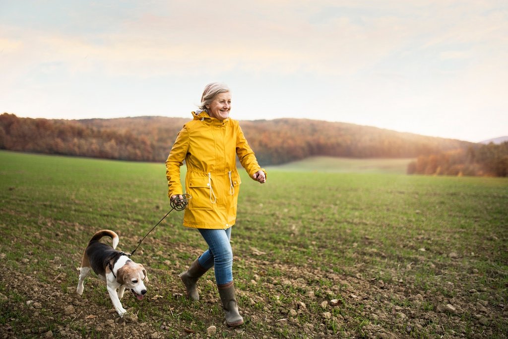 Older woman walking dog