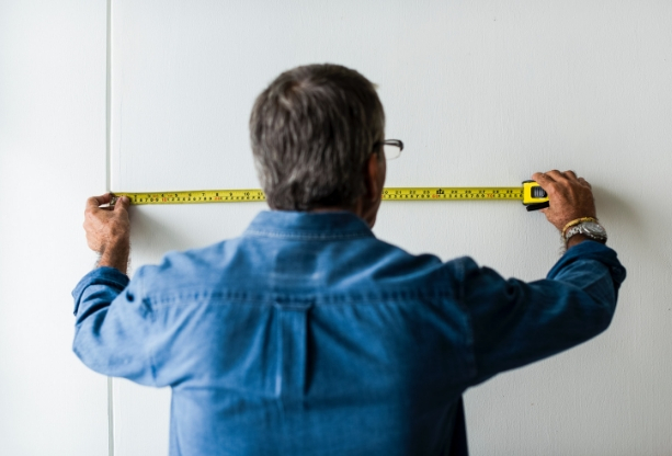 Older man measuring for stair lift installation 